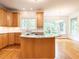 Inviting kitchen featuring a central island, granite counters and ample natural light at 203 Chilcott Ln, Apex, NC 27502