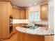 Gourmet kitchen featuring granite countertops, stainless appliances, and a cooktop island at 203 Chilcott Ln, Apex, NC 27502