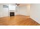 Spacious living room with a cozy fireplace and elegant hardwood floors at 203 Chilcott Ln, Apex, NC 27502