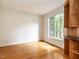 Well-lit home office with hardwood floors, built-in shelving, granite countertop, and a large window for natural light at 203 Chilcott Ln, Apex, NC 27502
