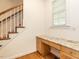 Home office area with built in desk by staircase at 203 Chilcott Ln, Apex, NC 27502