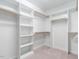 Spacious walk-in closet with built-in shelving and multiple rods for optimal organization at 203 Chilcott Ln, Apex, NC 27502