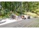 Relaxing backyard deck with ample seating and a peaceful view of the surrounding trees at 203 Old Forest Creek Dr, Chapel Hill, NC 27514