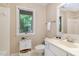 Charming bathroom with tub, vanity, and a window showcasing a lush view at 203 Old Forest Creek Dr, Chapel Hill, NC 27514