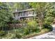 Two-story home with stone retaining wall and lush surrounding trees at 203 Old Forest Creek Dr, Chapel Hill, NC 27514