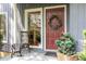 Charming front entrance with decorative wreath, stylish seating, and flagstone patio at 203 Old Forest Creek Dr, Chapel Hill, NC 27514