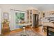 Sunlit kitchen features hardwood floors, stainless steel appliances, and an adjacent patio door at 203 Old Forest Creek Dr, Chapel Hill, NC 27514