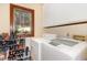 Functional laundry room features modern washer and dryer, plus storage shelves at 203 Old Forest Creek Dr, Chapel Hill, NC 27514