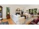 Elegant living room with hardwood floors, fireplace, and large windows at 203 Old Forest Creek Dr, Chapel Hill, NC 27514