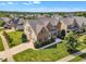 Aerial view of home showcasing mature trees, manicured lawn, and long driveway in a residential neighborhood at 208 Bridle Boast Rd, Cary, NC 27519