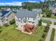 Aerial view of home featuring a wooden deck, manicured lawn, and lush landscaping in a neighborhood setting at 208 Bridle Boast Rd, Cary, NC 27519