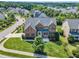 Beautiful aerial view of a traditional brick home with mature trees, landscaping, and a well-manicured lawn at 208 Bridle Boast Rd, Cary, NC 27519