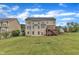 Lush backyard featuring a tiered deck, mature trees, and manicured lawn, perfect for outdoor gatherings at 208 Bridle Boast Rd, Cary, NC 27519