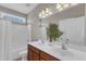 Bright bathroom featuring a double sink vanity with dark wood, a bathtub, and a large mirror at 208 Bridle Boast Rd, Cary, NC 27519