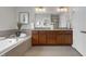 Large bathroom features a soaking tub, double sinks, and a tile surround at 208 Bridle Boast Rd, Cary, NC 27519