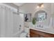 Bright bathroom with a white shower, vanity and a round mirror above the sink at 208 Bridle Boast Rd, Cary, NC 27519