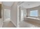 View into bathroom with large tub and tile surround, with hallway entrance to bedroom at 208 Bridle Boast Rd, Cary, NC 27519
