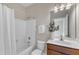 Classic bathroom featuring a shower-tub combo, pristine white fixtures, and a charming vanity at 208 Bridle Boast Rd, Cary, NC 27519