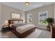 Well-appointed bedroom with a modern platform bed, two large windows, and warm, inviting lighting at 208 Bridle Boast Rd, Cary, NC 27519
