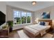 Bright bedroom with a large window, wooden bed frame and a cozy white rug at 208 Bridle Boast Rd, Cary, NC 27519