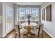 A bright breakfast nook features a round table and a view of the backyard at 208 Bridle Boast Rd, Cary, NC 27519