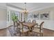 Elegant dining room with hardwood floors, a wooden table with seating for eight, and recessed lighting at 208 Bridle Boast Rd, Cary, NC 27519
