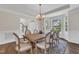 Bright dining area with large windows, hardwood floors, and an elegant wooden table with seating for six at 208 Bridle Boast Rd, Cary, NC 27519