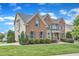 Attractive red brick and siding home with lush green lawn and neatly trimmed hedges at 208 Bridle Boast Rd, Cary, NC 27519