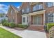Inviting brick front porch with double doors and well-maintained landscaping at 208 Bridle Boast Rd, Cary, NC 27519