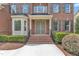 Charming front door entrance with brick steps and elegant black railing at 208 Bridle Boast Rd, Cary, NC 27519
