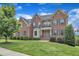 Beautiful brick two-story home featuring a manicured lawn, mature trees, and a welcoming front porch at 208 Bridle Boast Rd, Cary, NC 27519