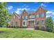 Beautiful red brick two-story home with manicured lawn and mature landscaping at 208 Bridle Boast Rd, Cary, NC 27519
