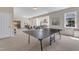 Expansive game room offering an open layout with a ping pong table and plenty of natural light at 208 Bridle Boast Rd, Cary, NC 27519