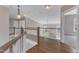 Well-lit hallway with wooden floors, white railings and a view of the outdoors at 208 Bridle Boast Rd, Cary, NC 27519
