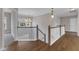 Open hallway with hardwood floors, a chandelier and natural light from a nearby window at 208 Bridle Boast Rd, Cary, NC 27519