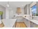 This is a well-lit kitchen featuring gray cabinets, an island, and stainless steel appliances at 208 Bridle Boast Rd, Cary, NC 27519