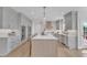 Modern kitchen featuring an island with bar stools, stainless steel appliances, and sleek countertops at 208 Bridle Boast Rd, Cary, NC 27519