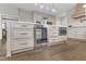 This kitchen features a cooler, microwave, gray cabinets, and an island at 208 Bridle Boast Rd, Cary, NC 27519
