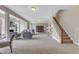 Expansive living area features staircase, neutral decor, and open layout perfect for entertaining at 208 Bridle Boast Rd, Cary, NC 27519