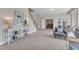 Bright living area features a staircase, stylish console table and comfortable seating at 208 Bridle Boast Rd, Cary, NC 27519