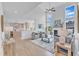Spacious living room featuring a fireplace, large windows, comfortable seating, and open access to the kitchen at 208 Bridle Boast Rd, Cary, NC 27519