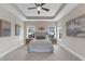 Spacious main bedroom with a tray ceiling, plush carpet, and bright natural light from large windows at 208 Bridle Boast Rd, Cary, NC 27519