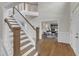 Elegant foyer with a beautiful staircase and wood flooring with views to the office at 208 Bridle Boast Rd, Cary, NC 27519