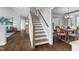 Elegant wooden staircase with dining area view, featuring hardwood flooring at 208 Bridle Boast Rd, Cary, NC 27519