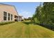 A serene backyard featuring lush green grass, a fence, and adjacent trees for privacy at 211 Ibis Ln, Durham, NC 27703