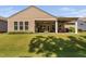 Inviting backyard featuring a covered patio with outdoor seating and ample green space at 211 Ibis Ln, Durham, NC 27703