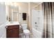 Full bathroom features a shower and tub combo, brown vanity and neutral color palette at 211 Ibis Ln, Durham, NC 27703