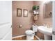 Half-bathroom with decorative wallpaper and a pedestal sink at 211 Ibis Ln, Durham, NC 27703