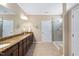 Bathroom with granite countertops, double sinks, and a walk-in shower at 211 Ibis Ln, Durham, NC 27703
