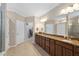 Bathroom featuring granite countertops, double sinks, and ample cabinet space at 211 Ibis Ln, Durham, NC 27703